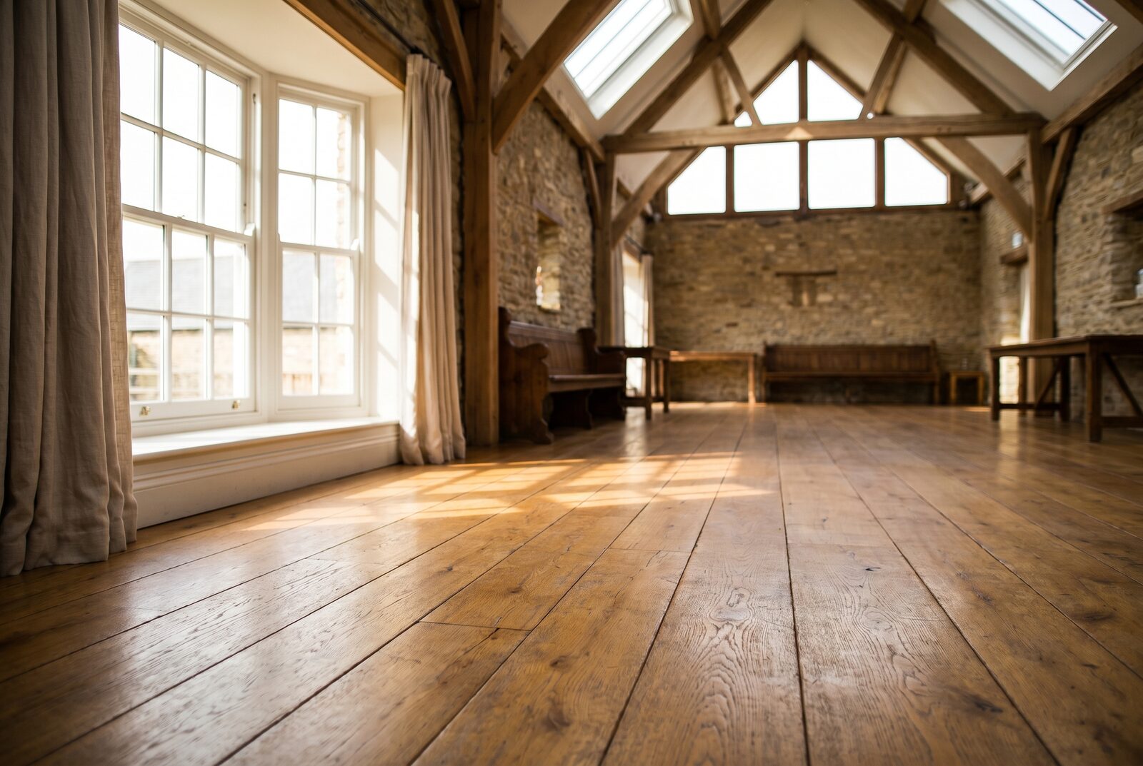 Residential-feel oak bedroom flooring under window light — boutique B&B
