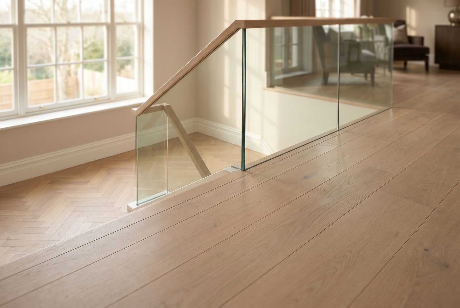 Glass-balustrade staircase descending to a herringbone landing
