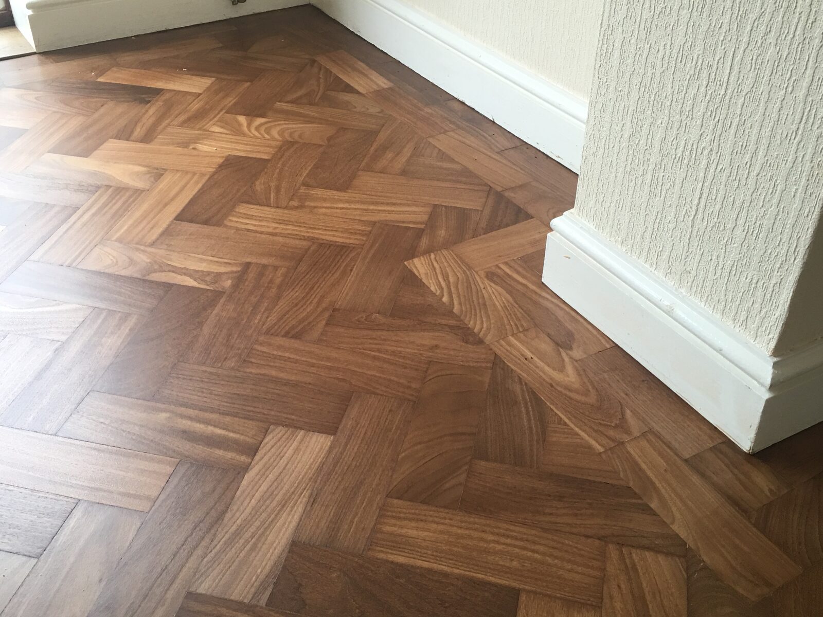 Restored teak herringbone parquet in Chichester