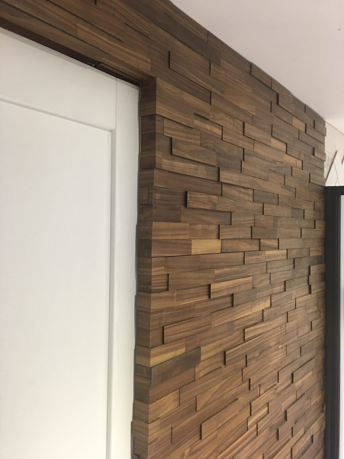 Walnut timber wall cladding laid by Forrestal Flooring
