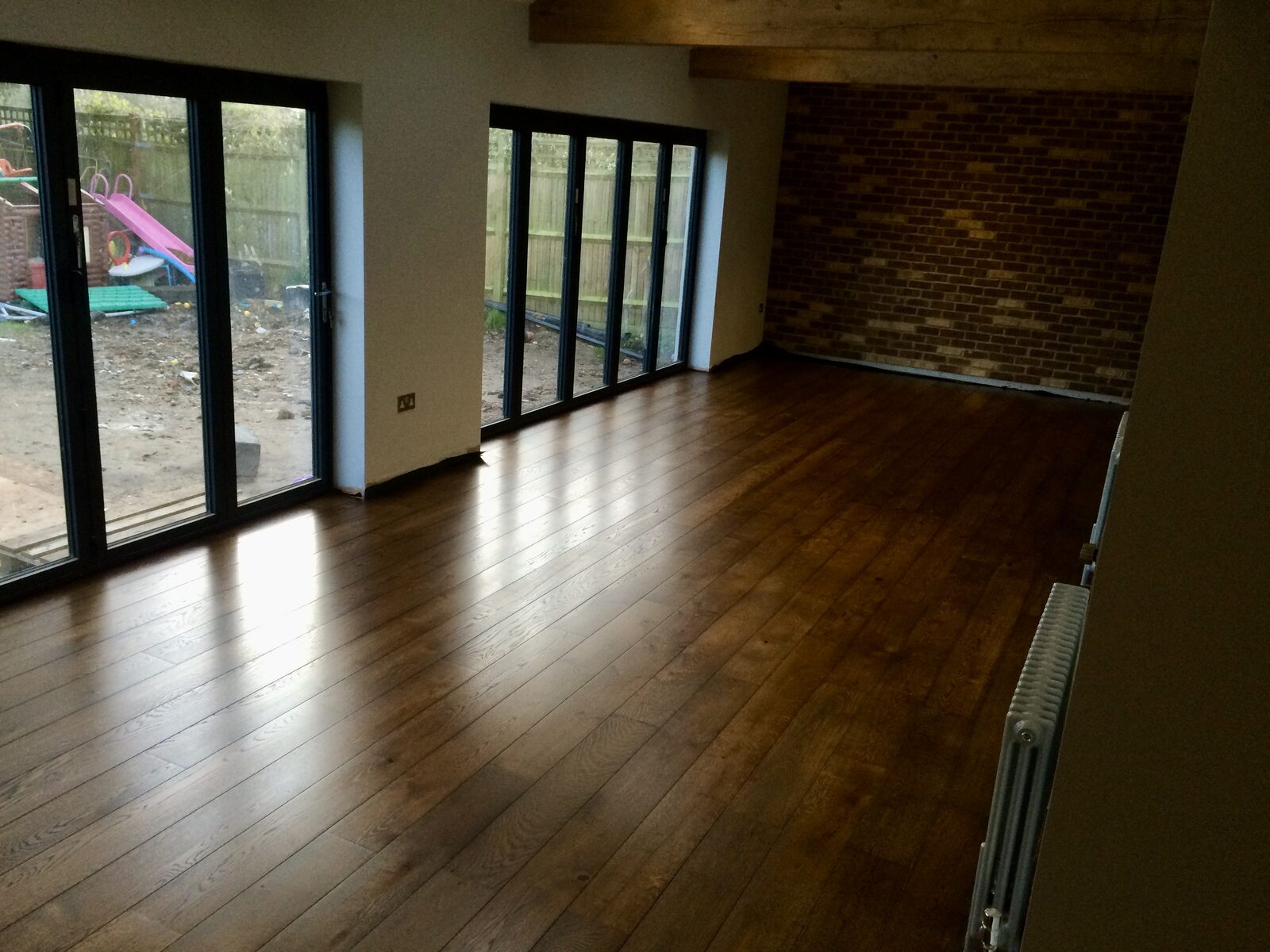 Restored dark-toned engineered oak plank flooring in a Haslemere home