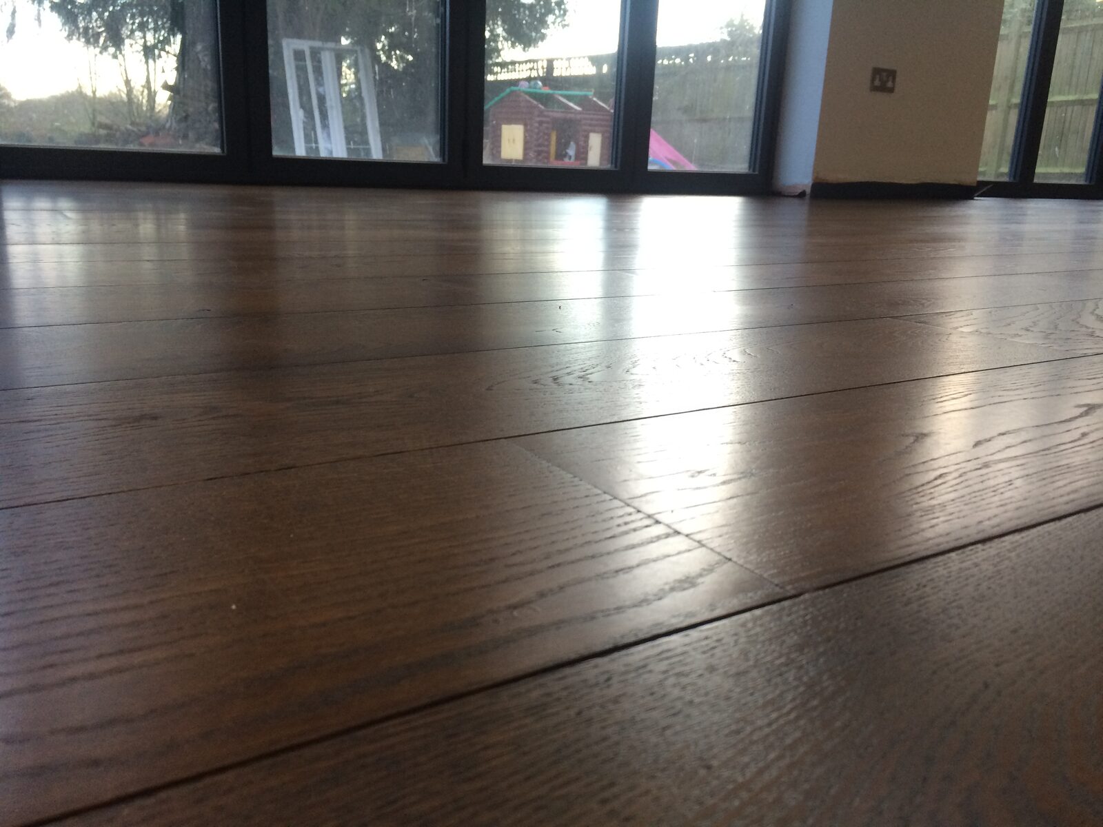 Restored dark-toned engineered oak plank flooring in Midhurst