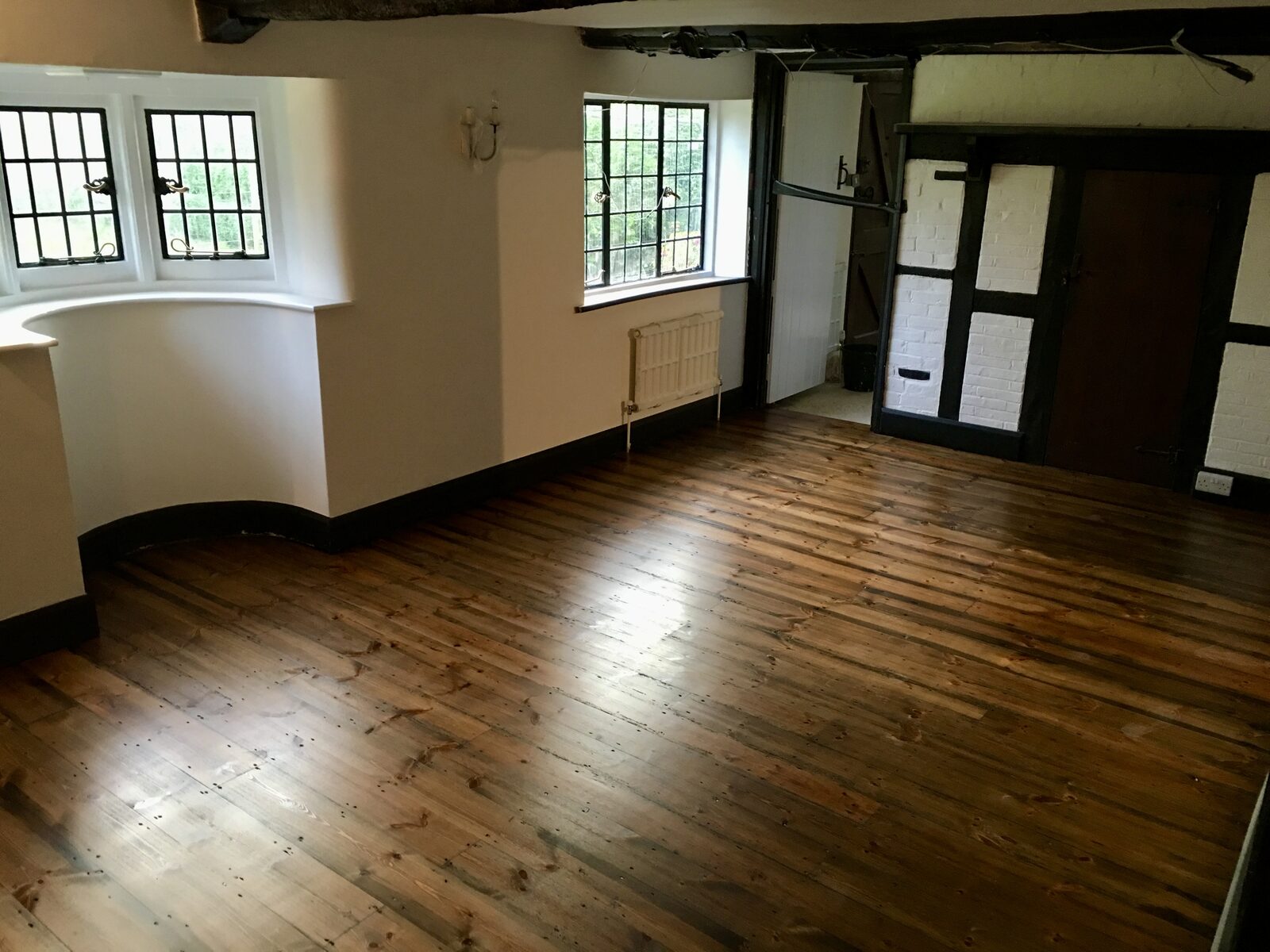Restored period pine floorboards in an Oving home