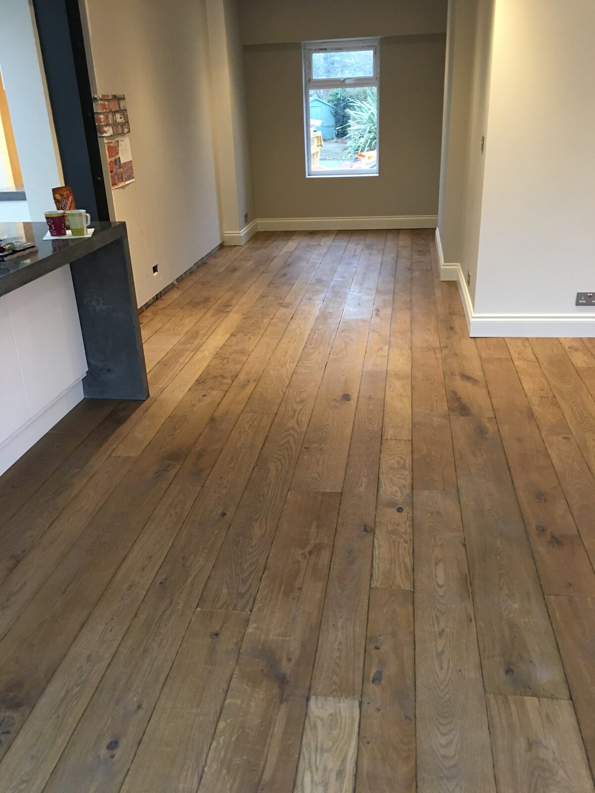 Rustic engineered oak plank flooring, of the kind we lay in Lindfield & Cuckfield homes
