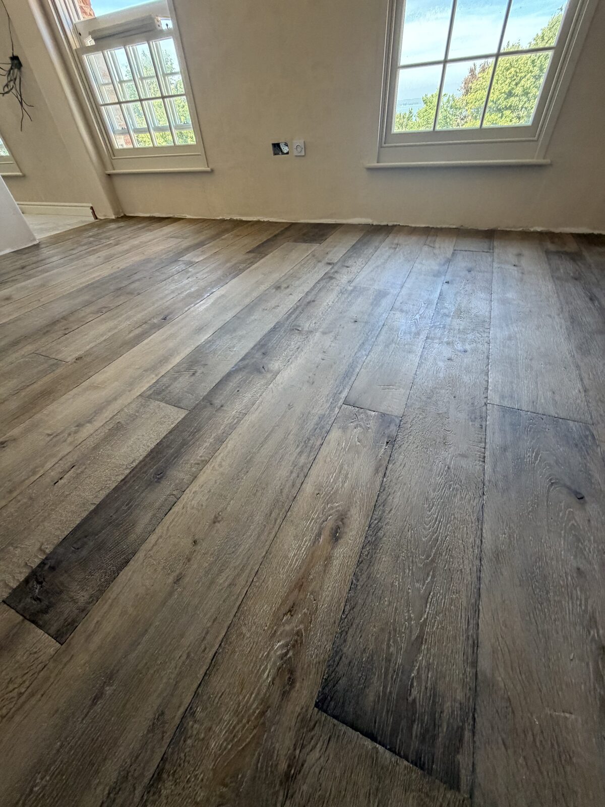 Rustic engineered plank flooring, of the kind we lay in Pulborough & Storrington homes