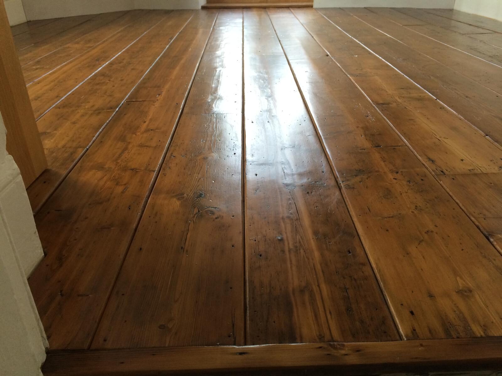 Restored reclaimed pine wide-board flooring